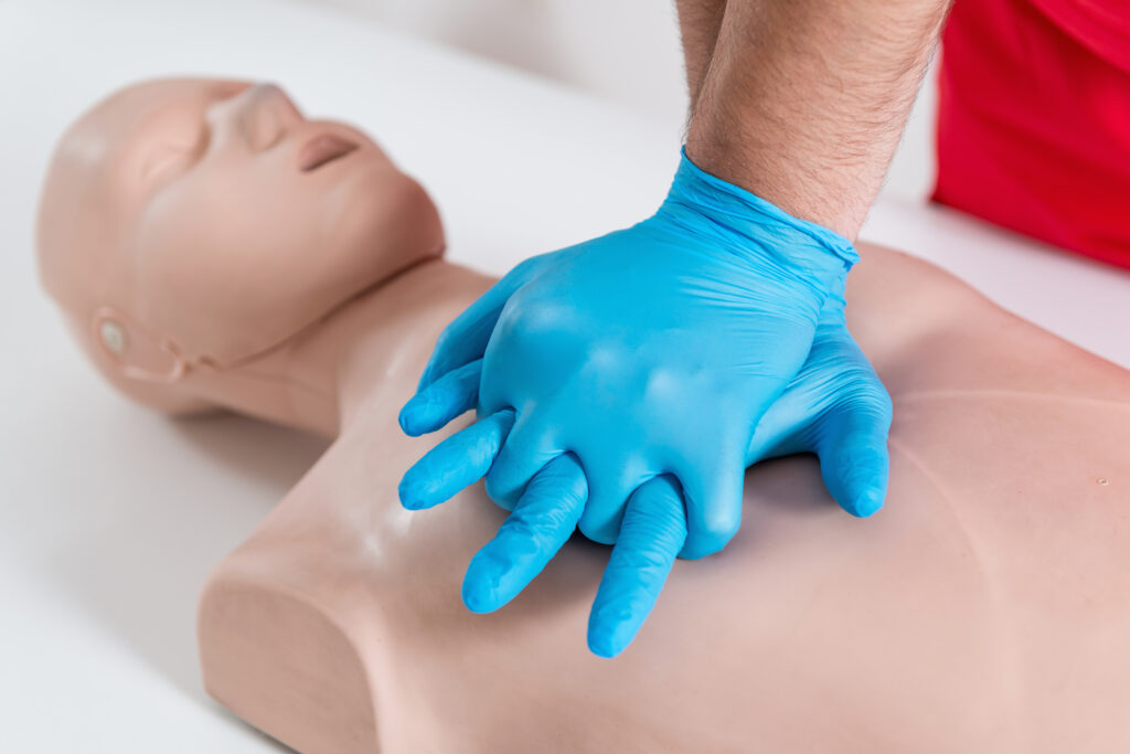 CPR training demonstration with a manikin in a First Aid class