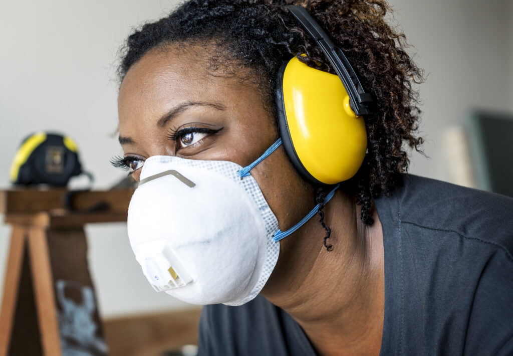 Woman wearing hearing protection and a respirator